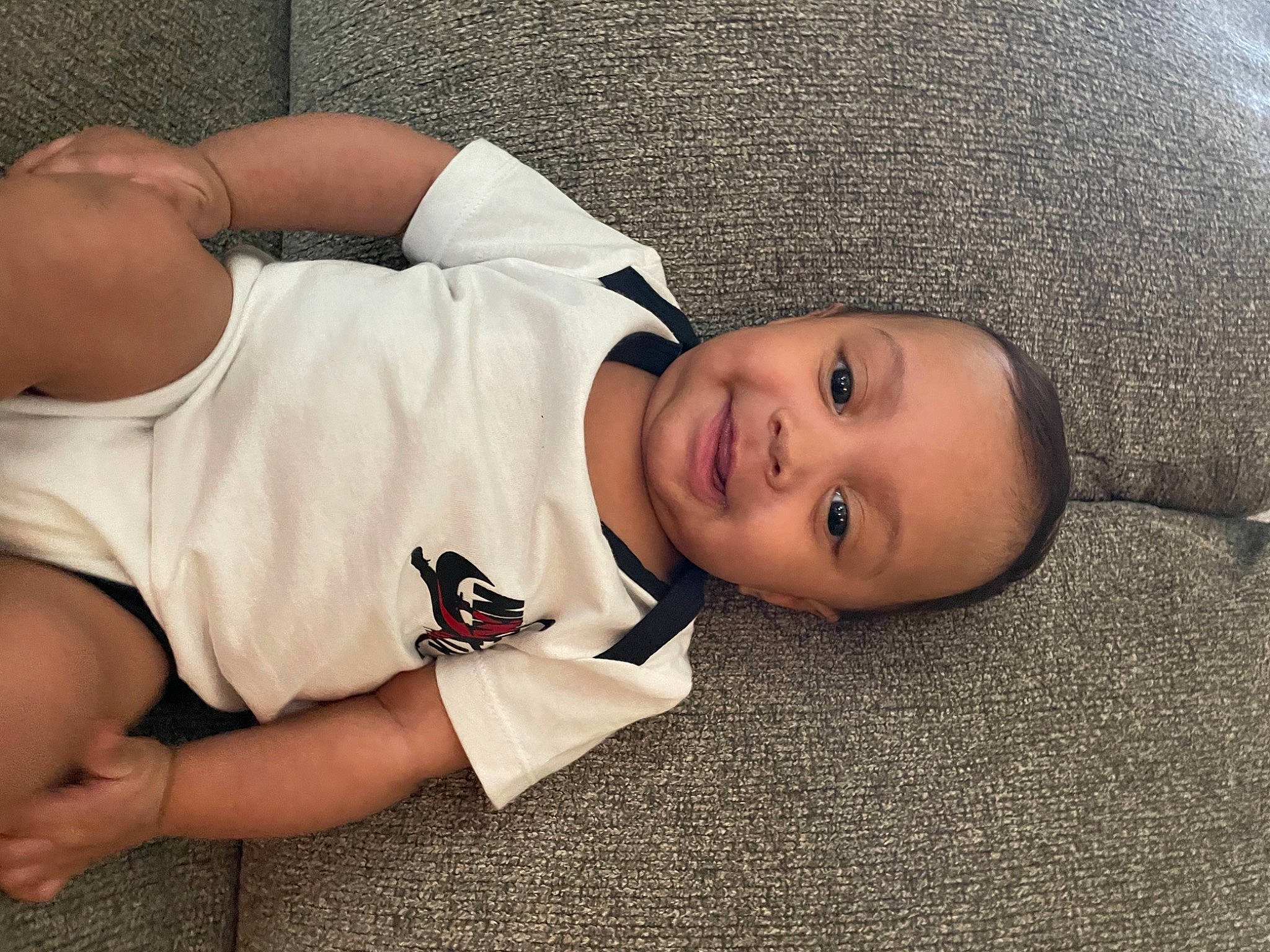Hezekiah joined the competition — help win amazing prizes! arm, baby_toddler_clothing, child, comfort, elbow, finger, flash_photography, flooring, happy, human_body, joint, joy, mouth, nose, person, sitting, skin, sleeve, smile, t_shirt