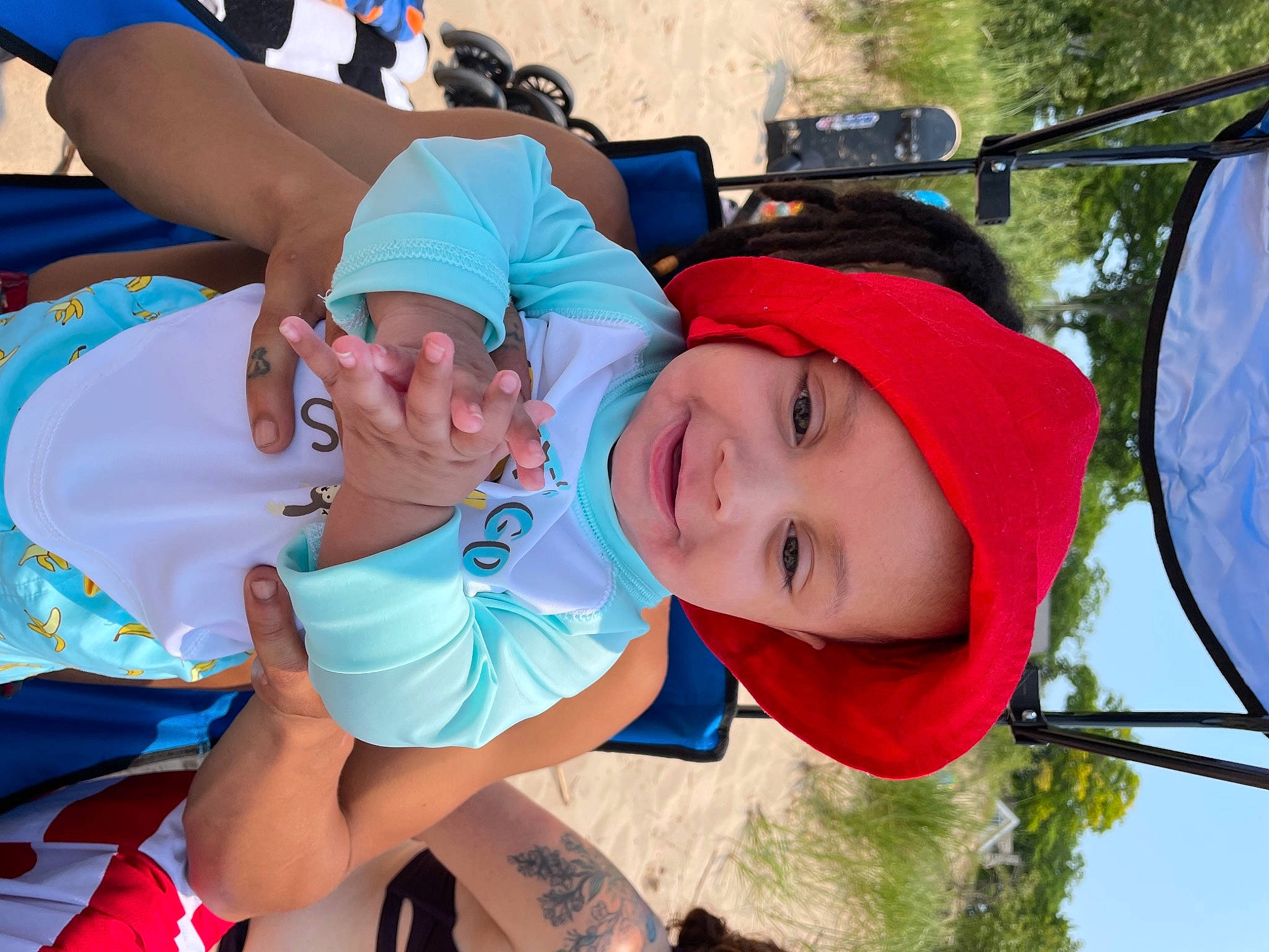 Hezekiah is registered to the contest to win money with this photo: blue, child, electric_blue, event, fun, grass, happy, hat, headgear, headwear, joy, leisure, person, pink, plant, recreation, shorts, smile, summer, sun_hat