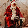 santa_claus, dog, christmas, holiday, wreath, red_suit, beard, glasses, black_boots, wooden_floor, chair, indoor, festive, decoration, pet, smiling, portrait, winter, fur, happy