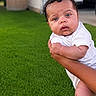 Carly is registered to the contest to win money with this photo: baby, infant, child, outdoor, grass, house, lawn, person, curious, holding, skin, white_clothing, hands, foot, portrait, daylight, suburban, expression, young, cute