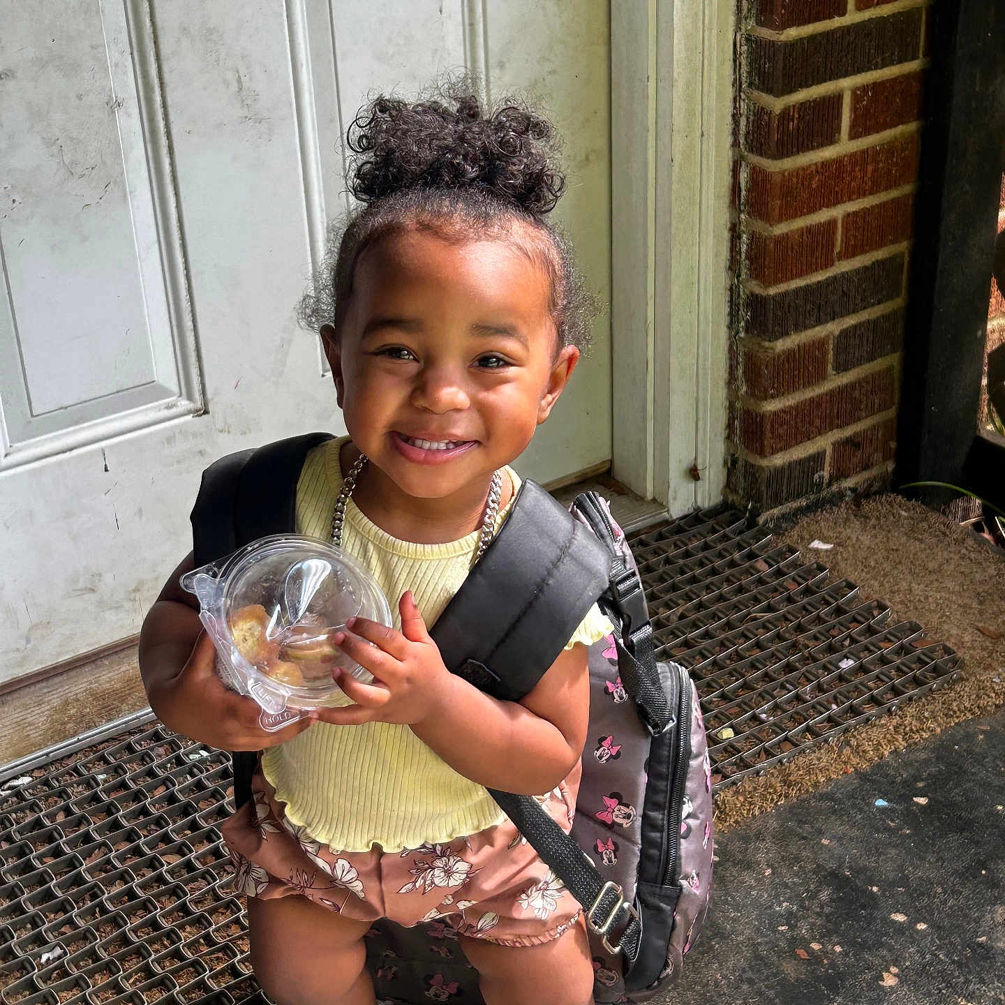 Aria is registered to the contest to win money with this photo: bag, brick, child, city, clothing, door, face, female, footwear, girl, head, jar, person, photography, portrait, road, shoe, shorts, street, urban
