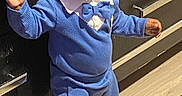 Zion is registered to the contest to win money with this photo: black_hair, blue_outfit, bow_tie, cabinet, child, curious, drawer, expression, floor, home, indoor, light, long_sleeves, pants, person, slippers, small_object, standing, toddler, wooden_floor