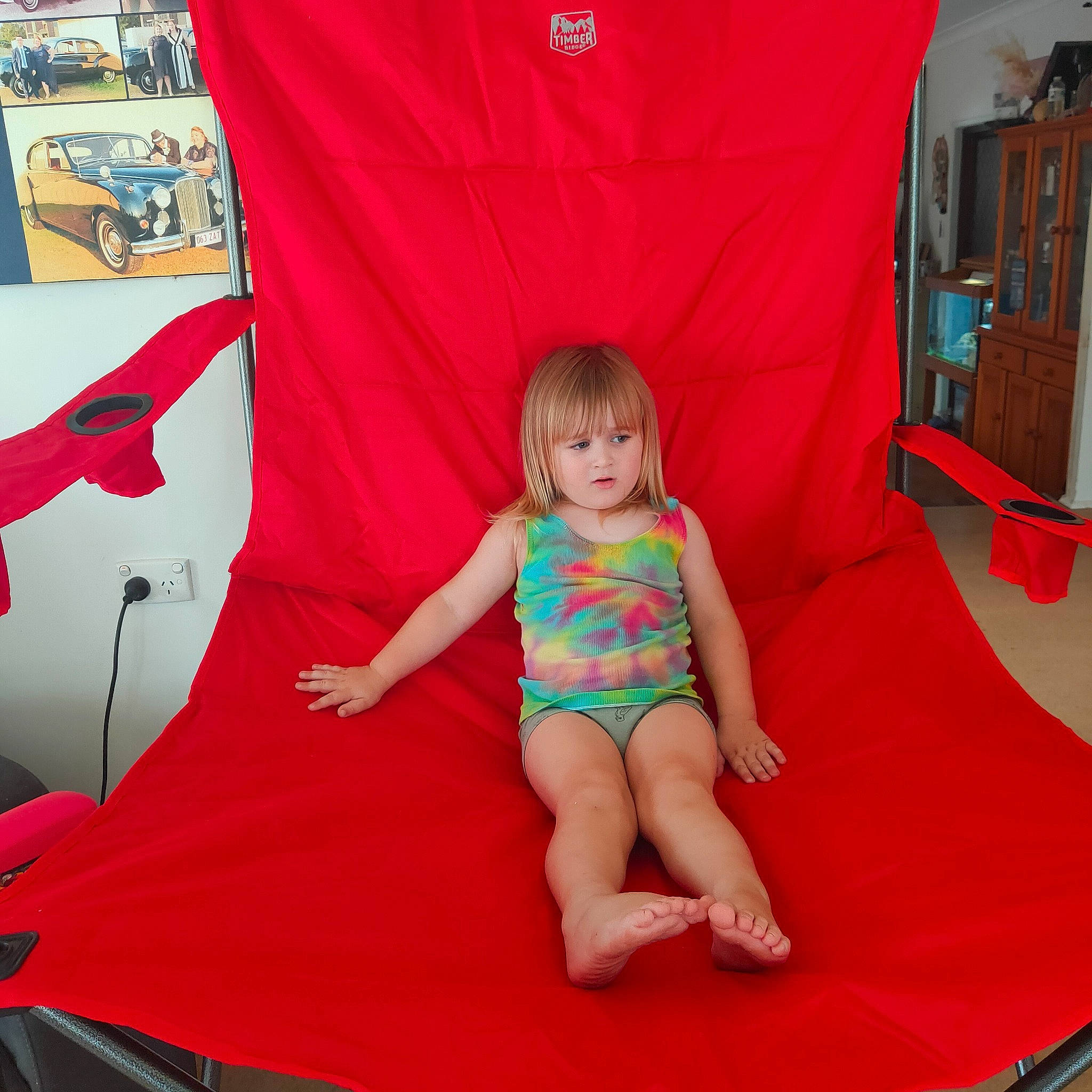 Sebastian is registered to the contest to win money with this photo: baby_toddler_clothing, barefoot, comfort, foot, fun, happy, human_leg, lap, leisure, magenta, person, pink, product, recreation, red, room, sitting, t_shirt, textile, thigh