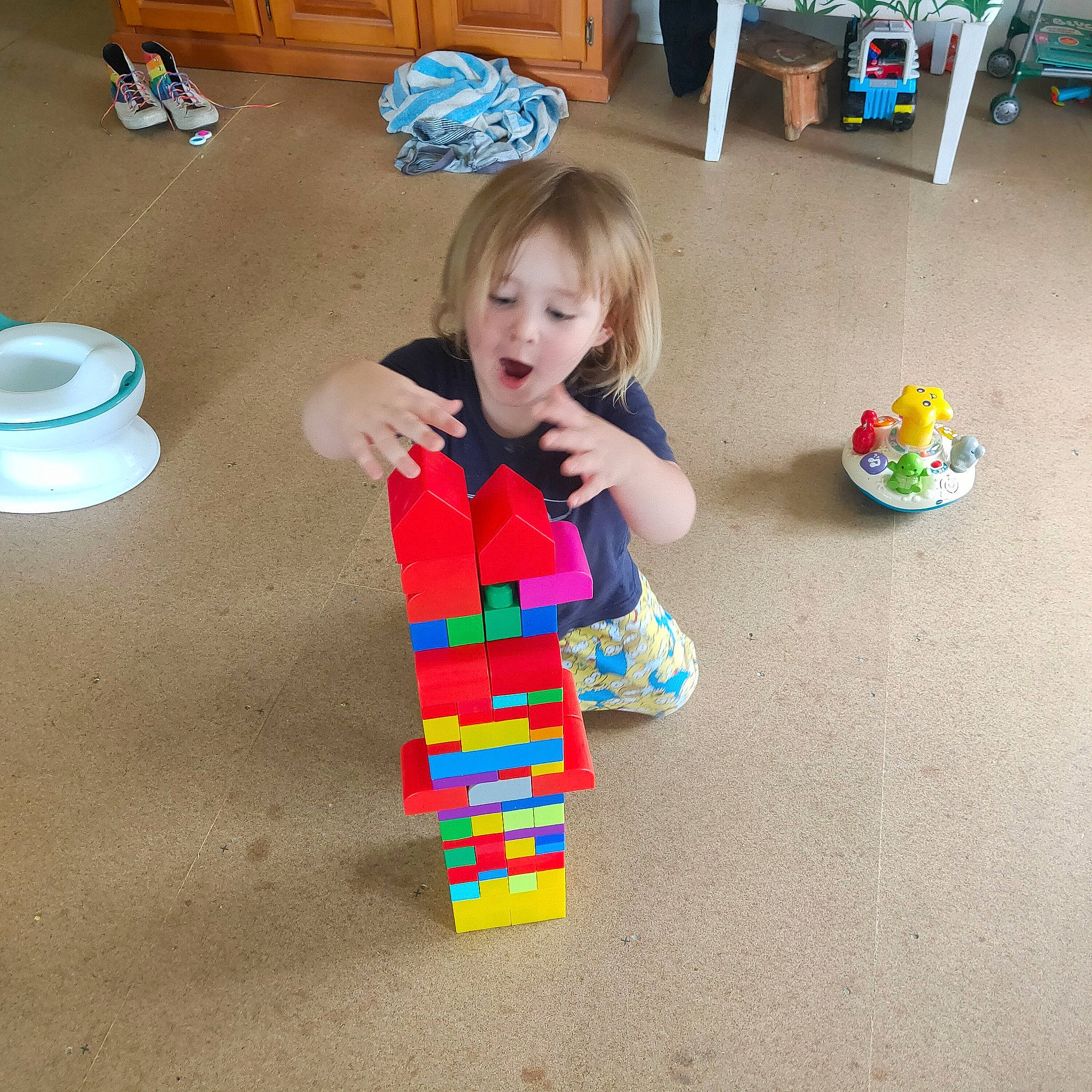 Sebastian is registered to the contest to win money with this photo: baby, baby_playing_with_toys, baby_toddler_clothing, baby_toys, child, educational_toy, floor, flooring, fun, interlocking_block, person, play, room, sharing, sitting, toddler, toy, toy_block, toy_vehicle, varnish