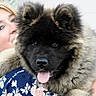 Baileys participe au concours pour gagner de l'argent avec cette photo : dog, puppy, fluffy, black_face, tongue_out, woman, smiling, holding, hug, floral_clothing, sunglasses, blonde_hair, portrait, close_up, happy, outdoor, pet, cute, friendship, affection