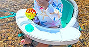 Brylee joined the competition — help win amazing prizes! baby, child, water, floating_chair, sun_hat, toy, outdoor, river, rocks, water_shallow, summer, playtime, curious, starfish_pattern, feet, sitting, nature, bright_colors, sunlight, cute