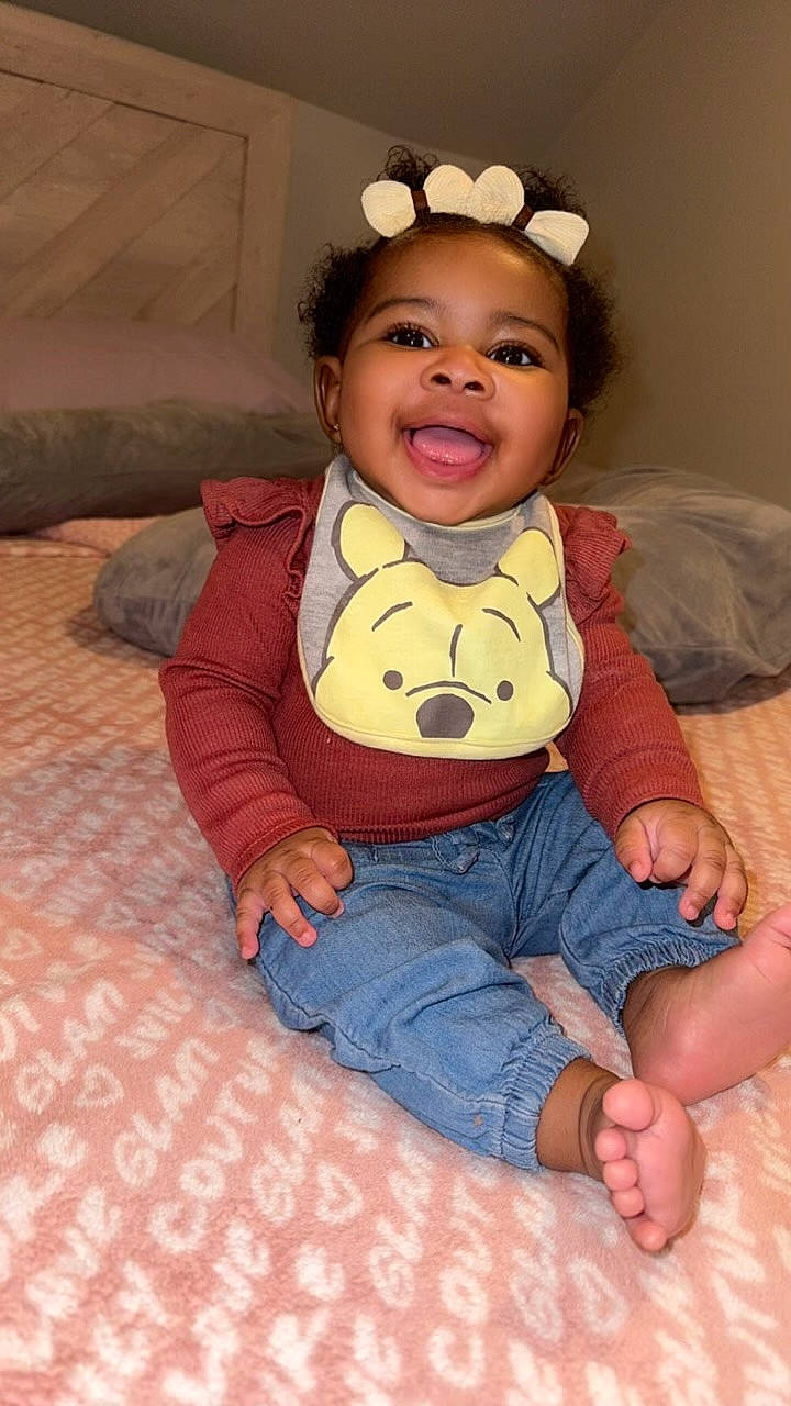 Skylar joined the competition — help win amazing prizes! baby, babylaughing, bed, bedroom, clothing, cushion, face, furniture, happy, head, homedecor, indoors, jeans, pants, person, photography, portrait, room, sitting, smile