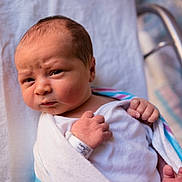 Braxton joined the competition — help win amazing prizes! newborn, baby, infant, wrapped, blanket, hospital, wristband, face, portrait, skin, hand, expression, cute, person, newborn_baby, indoors, closeup, head, lying_down, sleepwear