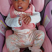 Si'Anna joined the competition — help win amazing prizes! baby, infant, car_seat, pink, headband, clothing, socks, hands, face, eyes, expression, child, cute, seatbelt, sitting, portrait, indoors, person, apparel, comfort