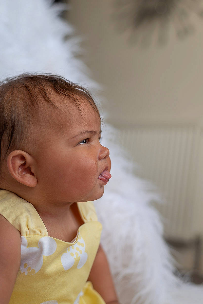 Imogen is registered to the contest to win money with this photo: baby, baby_toddler_clothing, bridal_accessory, brown_hair, cheek, child, dress, eyelash, flash_photography, grass, hair_accessory, happy, headpiece, iris, lip, neck, nose, peach, person, skin