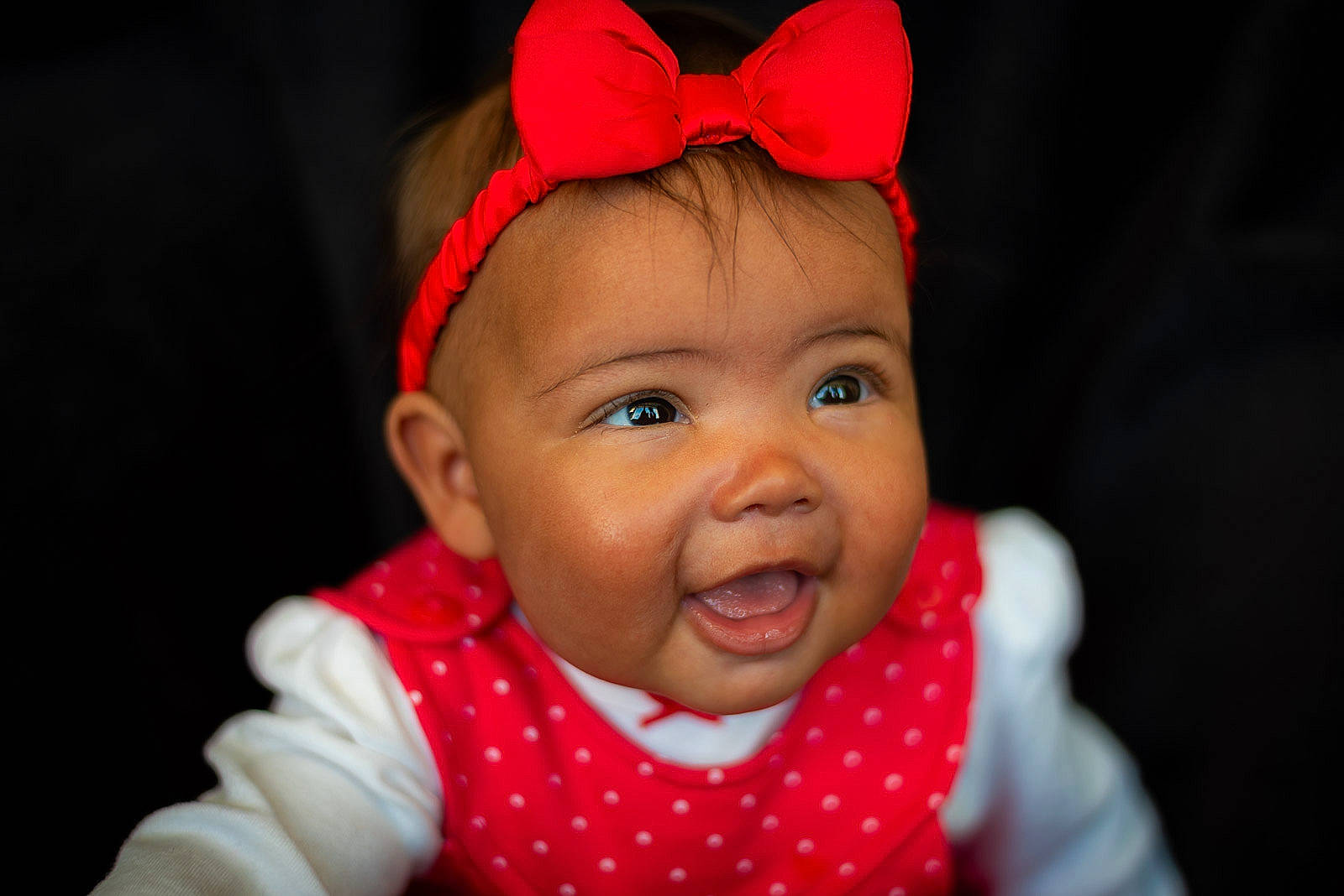 Imogen is registered to the contest to win money with this photo: baby, cheek, chin, costume_hat, ear, eye, eyebrow, hair, happy, headgear, human_body, iris, lip, mouth, neck, nose, person, pink, skin, smile