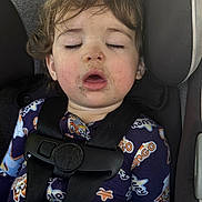 Oliver joined the competition — help win amazing prizes! child, toddler, sleeping, car_seat, seatbelt, curly_hair, pajamas, face, closed_eyes, mouth_open, dirt, indoors, car_interior, safety_harness, cute, young_child, resting, infant, seat, baby
