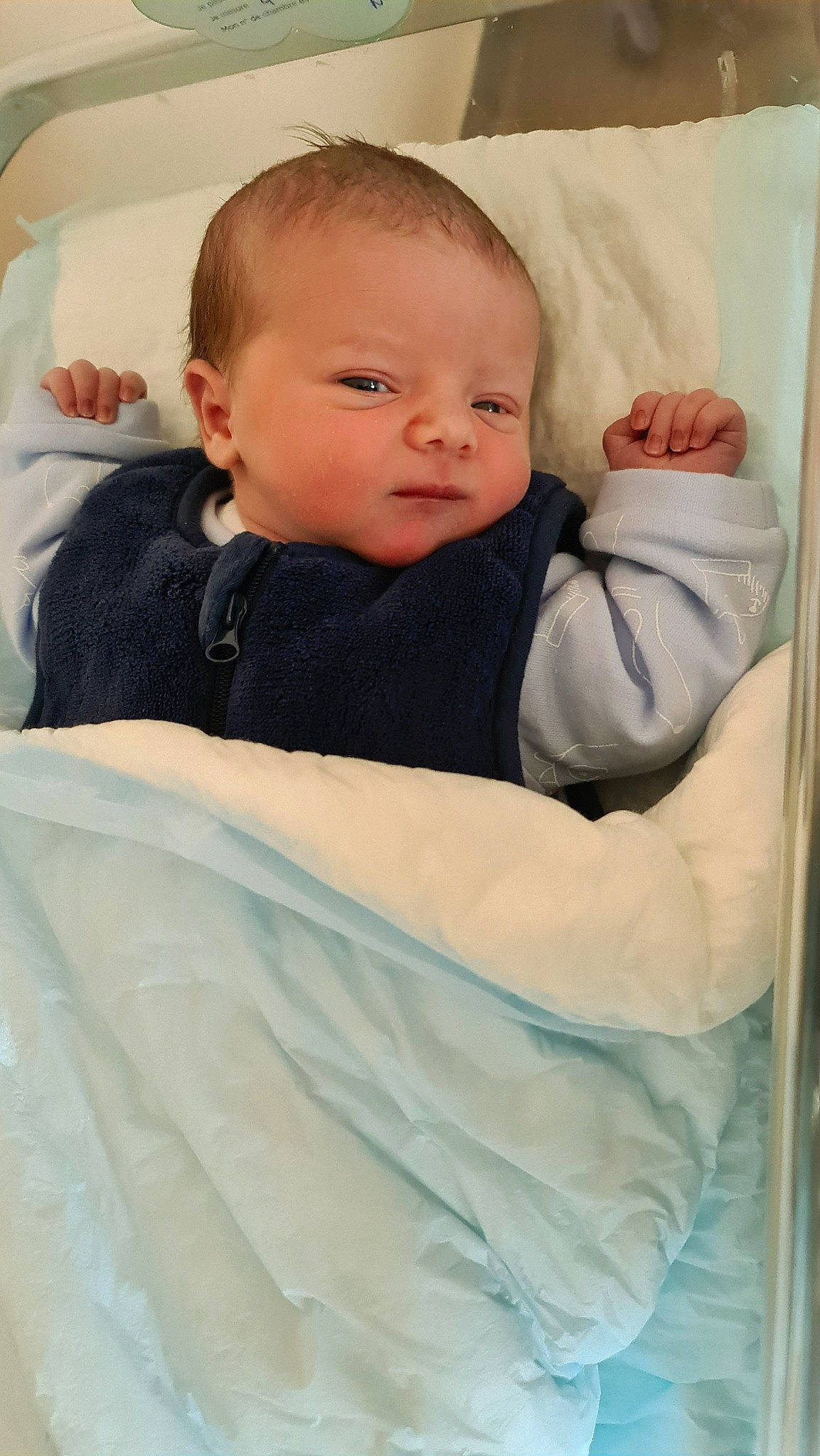 Rafael participe au concours pour gagner de l'argent avec cette photo : baby, baby_products, baby_sleeping, baby_toddler_clothing, cheek, child, comfort, eye, eyebrow, head, iris, linens, neck, outerwear, person, room, sitting, skin, sleeve, textile