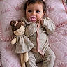 baby, child, pacifier, pigtails, doll, pink, blanket, quilted, embroidery, clothing, infant, cute, indoor, portrait, soft_lighting, toy, bed, comfort, person, sleepwear
