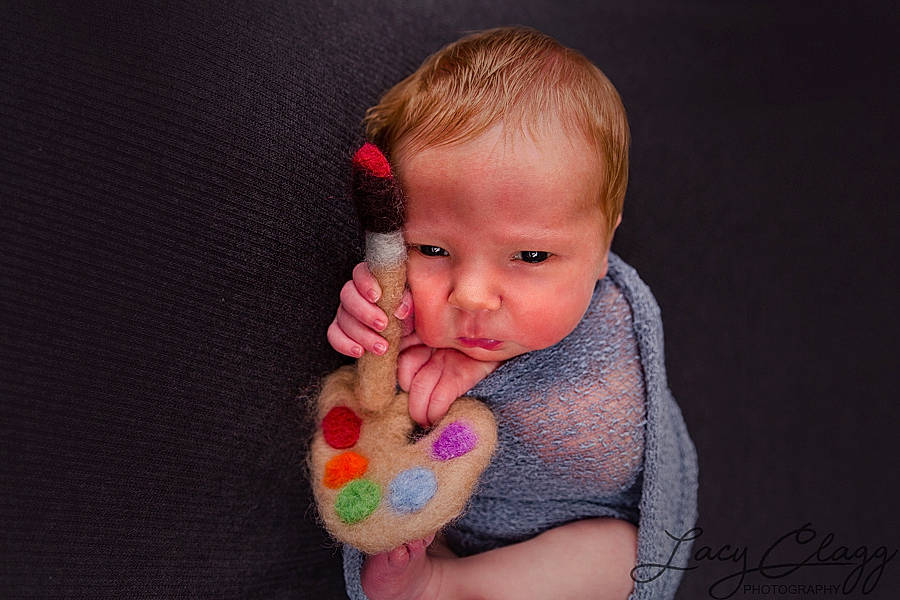 Malcolm is registered to the contest to win money with this photo: arm, baby, baby_toys, cheek, child, ear, eye, finger, hand, head, mouth, neck, nose, person, photography, pink, play, sitting, skin, thumb