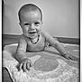 Yüna a rejoint le concours — aidez-le/la à gagner de superbes lots ! baby, infant, smiling, black_and_white, indoor, rug, floor, crawling, child, cute, necklace, hand, portrait, happy, expression, young, small, person, head, skin