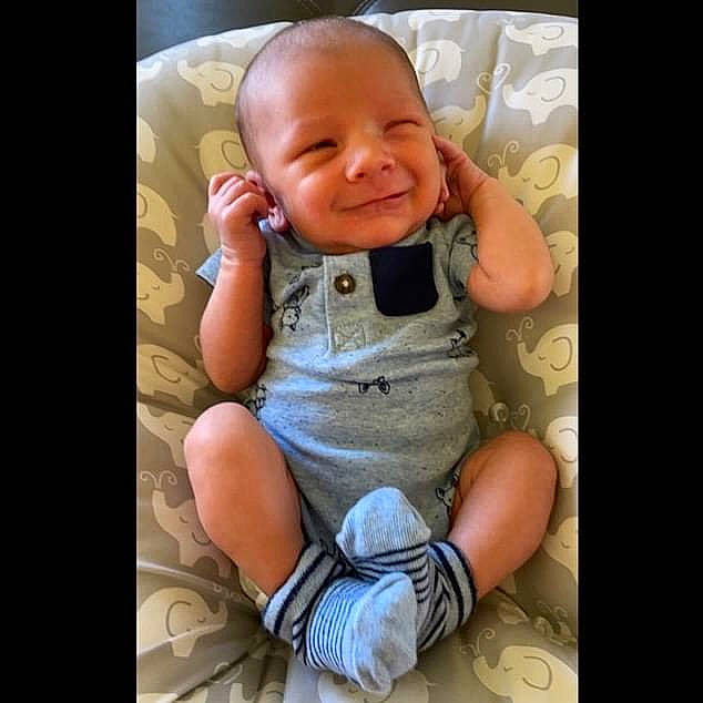 Jensen is registered to the contest to win money with this photo: baby, baby_toddler_clothing, child, comfort, flash_photography, foot, happy, human_leg, joy, knee, nail, pattern, person, photo_caption, sitting, skin, sleeve, smile, t_shirt, thigh