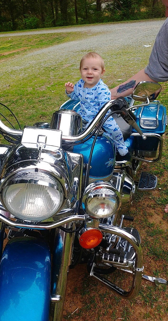 Luther is registered to the contest to win money with this photo: automotive_lighting, car, headlamp, joy, motor_vehicle, motorcycle, motorcycle_accessories, person, vehicle