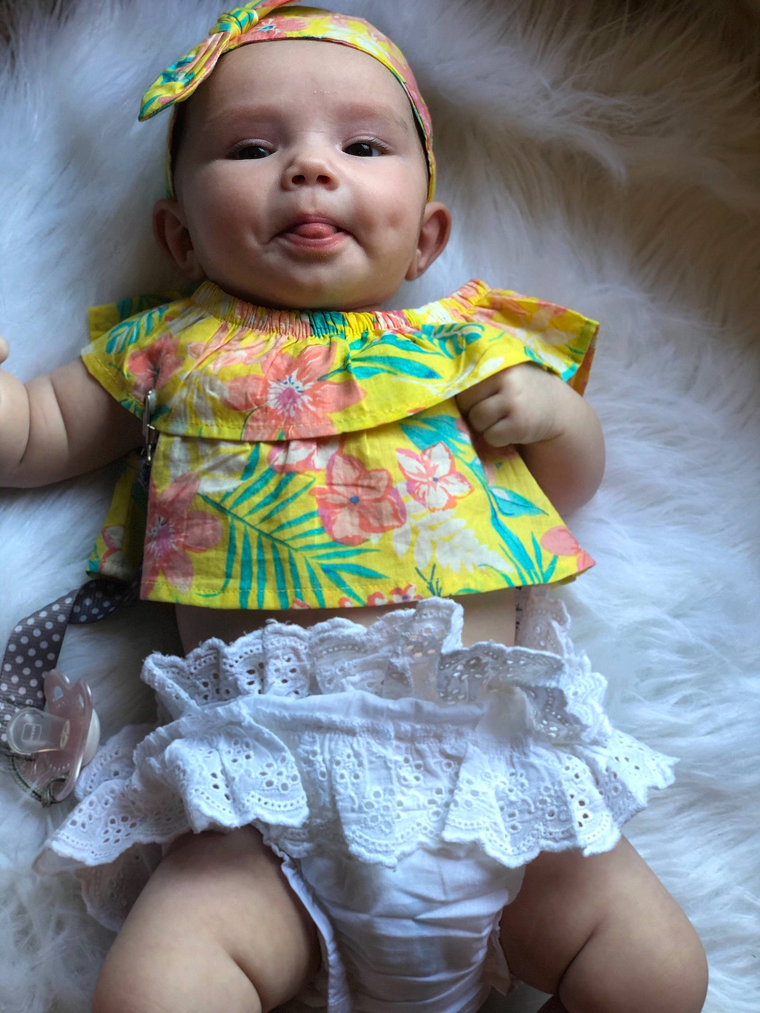 Jolie is registered to the contest to win money with this photo: baby, baby_toddler_clothing, cheek, child, design, dress, fashion_accessory, hair_accessory, headgear, iris, pattern, person, pink, play, skin, smile, textile, toddler, yellow
