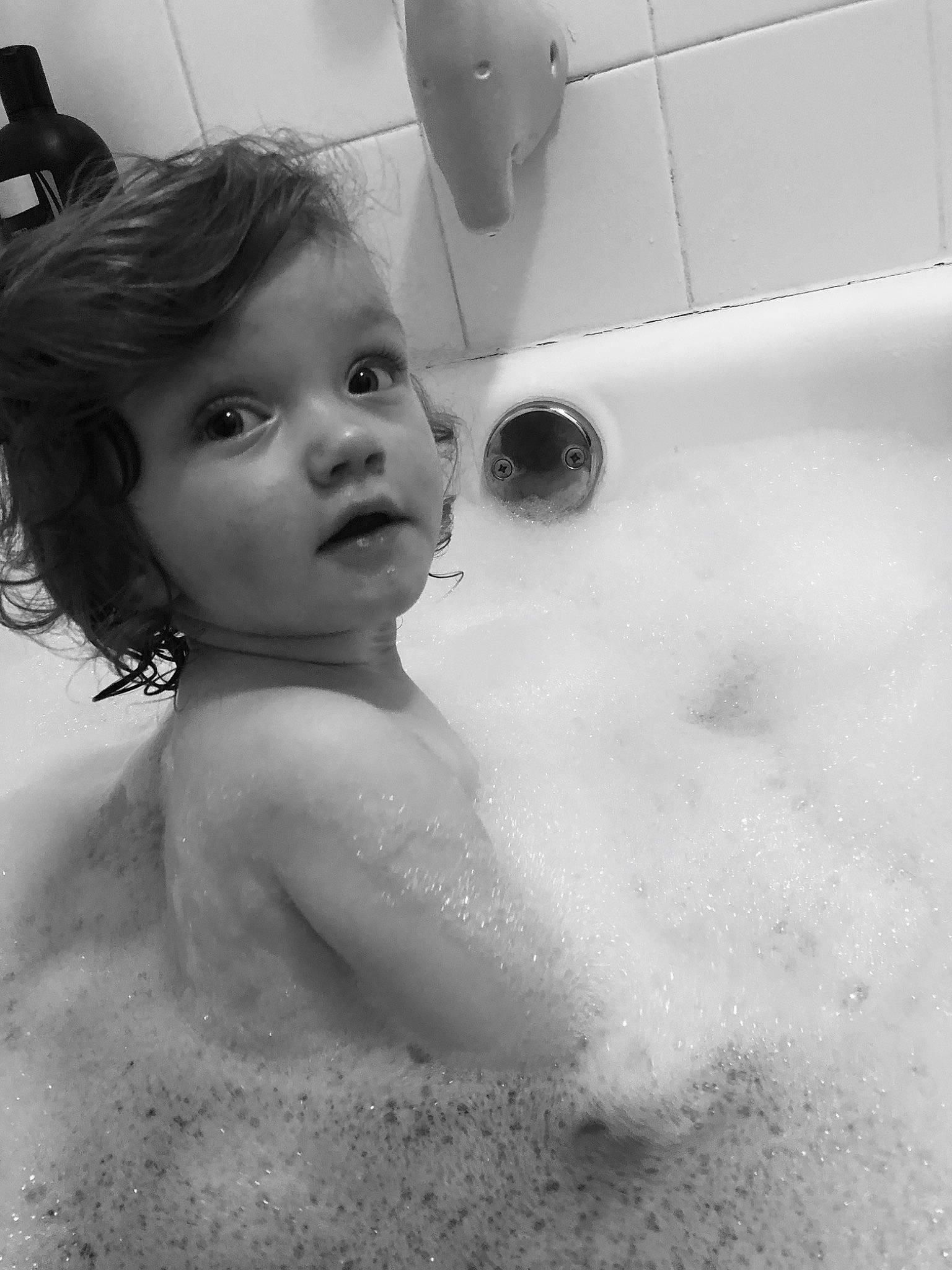 Riley Claire is registered to the contest to win money with this photo: bathing, bathroom, bathtub, black, black_and_white, child, eye, monochrome, person, photography, plumbing_fixture, room, skin, toddler, washing, water, white