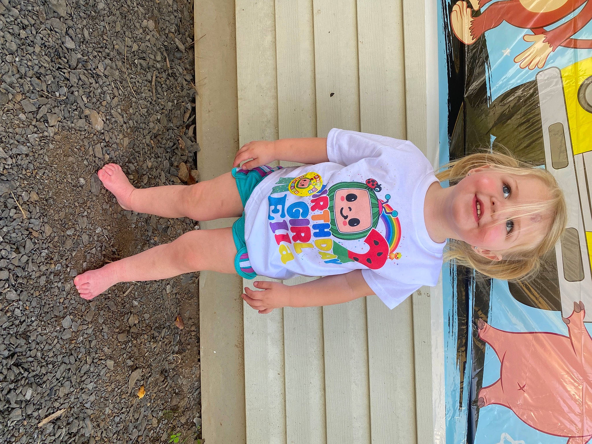 Ella is registered to the contest to win money with this photo: art, baby_toddler_clothing, barefoot, calf, child, foot, fun, happy, human_leg, joy, leisure, pattern, person, sandal, smile, thigh, toddler, vacation, wood, wrist