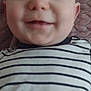 Elijah is registered to the contest to win money with this photo: baby, smiling, face, striped_shirt, child, close_up, portrait, infant, lying_down, blanket, texture, happy, young_child, cute, human, skin, head, eyes, mouth, clothing