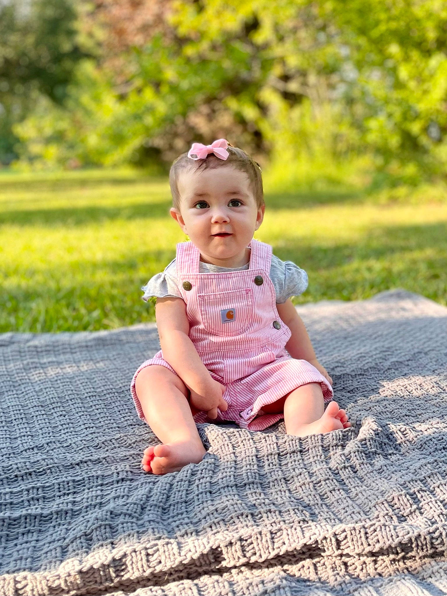 Adlee is registered to the contest to win money with this photo: baby, baby_toddler_clothing, child, denim, facial_expression, flooring, foot, fun, grass, happy, landscape, leisure, pattern, people_in_nature, person, plant, play, sitting, skin, toddler
