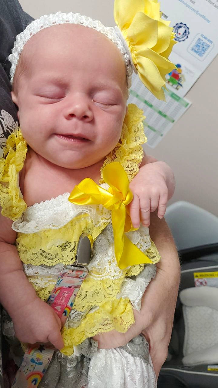 Anastasia is registered to the contest to win money with this photo: baby, baby_toddler_clothing, child, dress, facial_expression, fashion_accessory, finger, fun, gesture, hair_accessory, happy, headgear, headpiece, lei, organ, people_in_nature, person, pink, skin, toddler