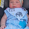 Charlee is registered to the contest to win money with this photo: baby, child, car_seat, blue_outfit, headband, flower, bib, elephant_print, infant, cute, smiling, seated, clothing, adorable, young_child, indoor, person, skin, face, comfort