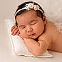 Olivia a rejoint le concours — aidez-le/la à gagner de superbes lots ! baby, sleeping, pillow, headband, flower, infant, peaceful, skin, closeup, portrait, cute, soft, cozy, resting, child, newborn, indoors, peace, face, relaxation