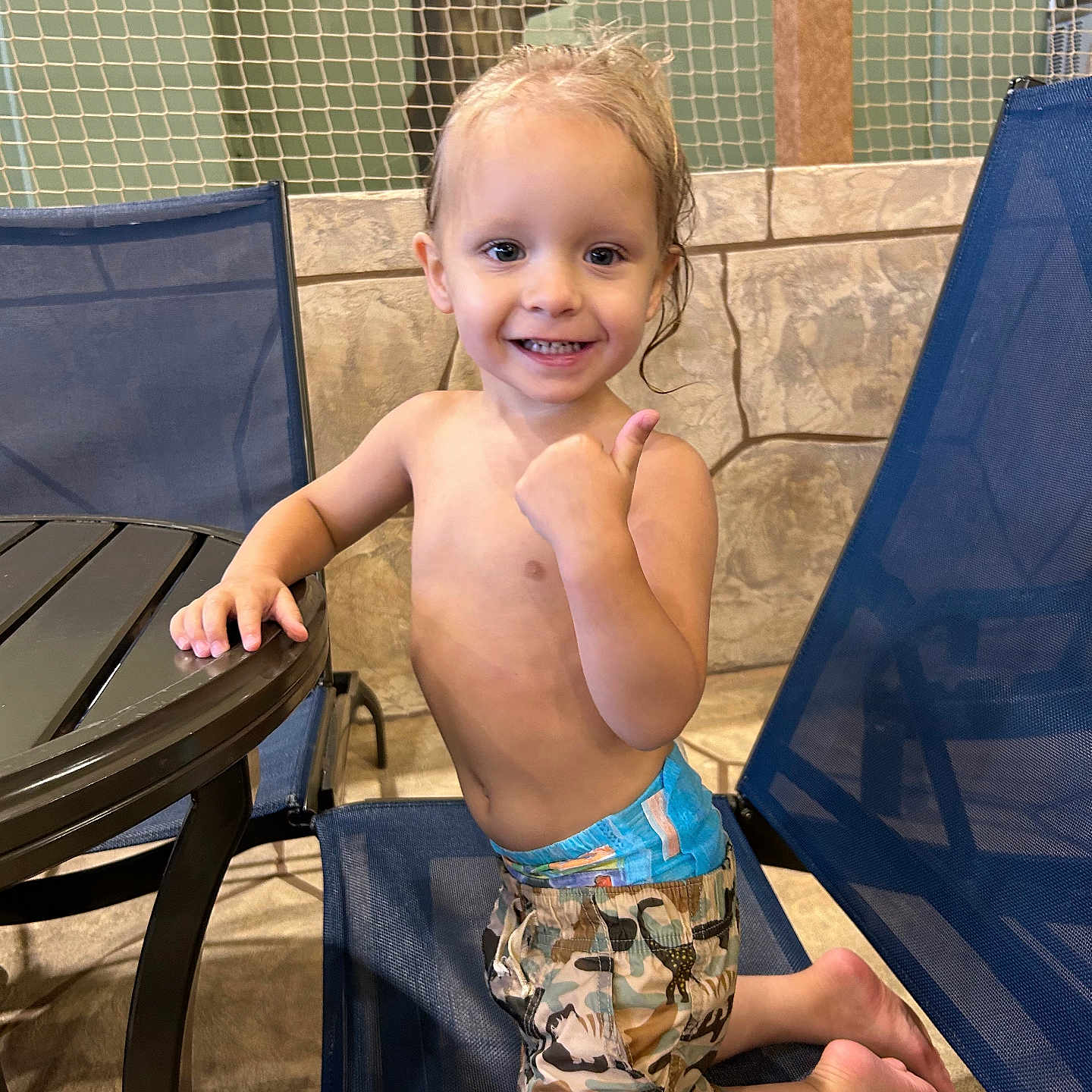 Wyatt is registered to the contest to win money with this photo: ankle, baby, bodypart, clothing, dress, face, finger, furniture, hand, head, pants, person, photography, plywood, portrait, shorts, sitting, summer, table, wood