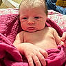 baby, newborn, infant, pink_towel, skin, hand, face, portrait, indoors, bedroom, blanket, curious, wrapped, young_child, person, soft_texture, cozy, expression, human, closeup