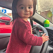 Chalom participe au concours pour gagner de l'argent avec cette photo : car_interior, child, clothing, curious, cute, dashboard, expression, face, hand, indoor, maroon, person, portrait, seat, steering_wheel, sweater, toddler, vehicle, window, young_child