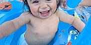 Chalom a rejoint le concours — aidez-le/la à gagner de superbes lots ! baby, blue, child, cute, diaper, float, fun, happy, inflatable, joy, outdoor, person, pirate_theme, play, pool, smiling, splash, summer, water, wet_hair