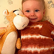 Arlo joined the competition — help win amazing prizes! toddler, child, stuffed_toy, tiger, smiling, bedspread, winnie_the_pooh, plush, orange, white, clothing, portrait, indoor, happy, cute, baby, cozy, soft_toy, playful, young