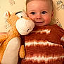 toddler, child, stuffed_toy, tiger, smiling, bedspread, winnie_the_pooh, plush, orange, white, clothing, portrait, indoor, happy, cute, baby, cozy, soft_toy, playful, young