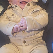 Swan participe au concours pour gagner de l'argent avec cette photo : baby, infant, smiling, tongue_out, cap, hat, onesie, beige_clothing, car_seat, seatbelt, hands, shoes, portrait, close_up, cheeks, eyes, button, cozy, happy, cute