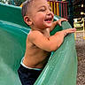 toddler, child, playground, slide, smiling, happy, outdoor, summer, fun, park, bare_chested, green_slide, play_equipment, daylight, joyful, person, leisure, nature, casual, active