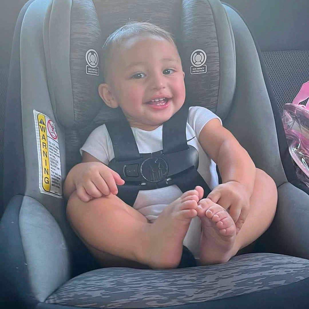 Ayce joined the competition — help win amazing prizes! baby, car_seat, child, smiling, happy, infant, safety_harness, car_interior, seat, cute, person, young_child, feet, casual_clothing, transportation, seatbelt, vehicle, car_window, portrait, sitting