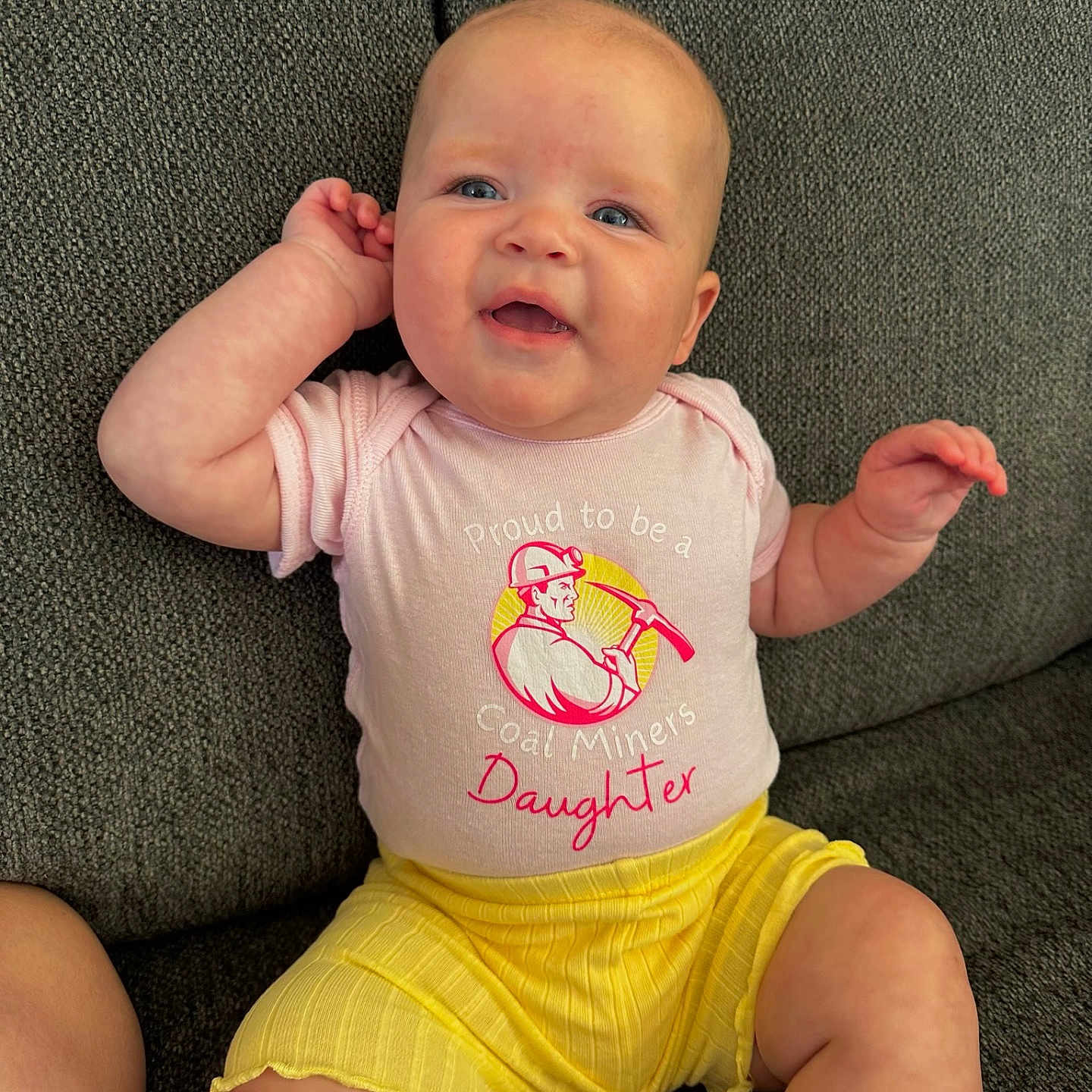 Juniper joined the competition — help win amazing prizes! baby, babylaughing, bodypart, clothing, couch, cushion, face, furniture, happy, head, homedecor, laughing, newborn, pants, person, photography, portrait, shorts, sitting, t_shirt
