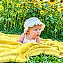 baby, bonnet, clothing, daisy, face, flower, grass, hat, head, herbal, herbs, leaf, outdoors, person, petal, photography, plant, portrait, summer, sunflower