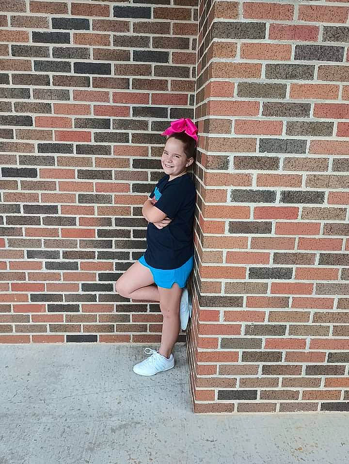 Annie is registered to the contest to win money with this photo: brick, brickwork, cap, child, concrete, electric_blue, flash_photography, fun, human_leg, joy, knee, leisure, magenta, pattern, person, pink, sitting, sportswear, stairs, t_shirt