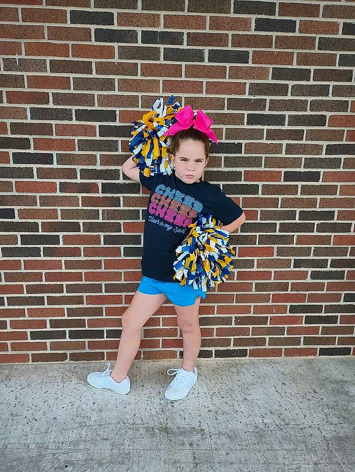 Annie joined the competition — help win amazing prizes! baby_toddler_clothing, brick, brickwork, child, costume_hat, door, electric_blue, fashion_accessory, fun, hat, human_leg, magenta, party_supply, pattern, person, personal_protective_equipment, pink, sleeve, sun_hat, t_shirt