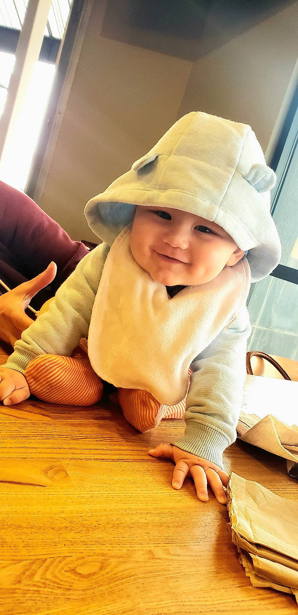 Leroy is registered to the contest to win money with this photo: baby, cap, child, finger, hand, hat, headgear, joy, leg, person, skin, smile, toddler, wood