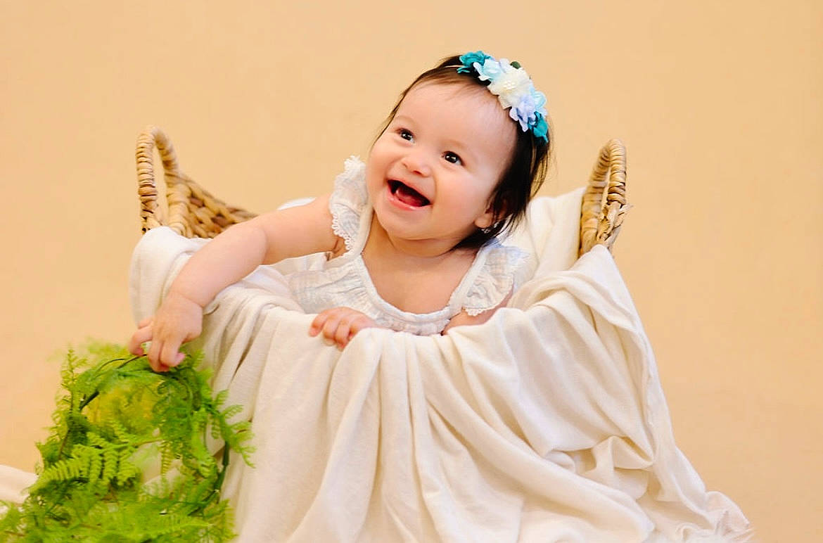 Raiya is registered to the contest to win money with this photo: baby, baby_toddler_clothing, bridal_accessory, bridal_clothing, clothing, dress, eye, flash_photography, fun, gesture, gown, happy, headband, headpiece, iris, jewellery, joy, person, sleeve, smile