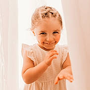 Ambre a rejoint le concours — aidez-le/la à gagner de superbes lots ! child, girl, smiling, braided_hair, white_dress, curtains, indoors, portrait, cute, happy, playful, young_child, light, soft_lighting, closeup, person, childhood, innocence, fun, peekaboo
