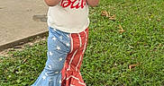 Eliana is registered to the contest to win money with this photo: casual, child, clothing, cute, daylight, eating, grass, nature, outdoor, pants, park, person, playground, shoes, snack, summer, tank_top, toddler, trees, young_child