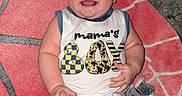 Andrew is registered to the contest to win money with this photo: baby, blanket, blue_shorts, boy, carpet, child, clothing, cute, face, happy, indoor, infant, lying_down, person, playtime, portrait, skin, sleeveless_shirt, smiling, young