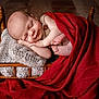 baby, newborn, infant, sleeping, wooden_bed, knitted_blanket, red_blanket, cozy, toes, hand, portrait, studio_photography, rustic, wood_floor, button, swaddle, peaceful, blanket, child, cute