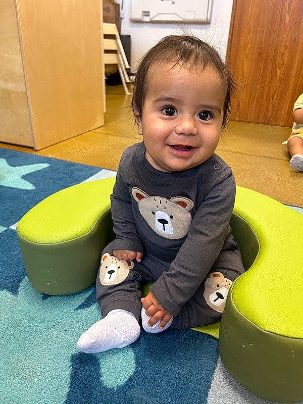 Kevin is registered to the contest to win money with this photo: baby, baby_playing_with_toys, baby_products, baby_toddler_clothing, child, floor, flooring, fun, grass, human_leg, joy, leisure, person, play, room, sitting, skin, smile, sock, toddler